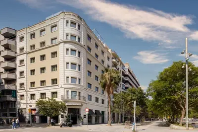 a large white building on a city street at Sercotel Amister Art Hotel Barcelona in Barcelona