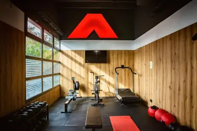 a gym with wood paneling and a large red light at Best Western Plus Hotel Alfa Aeropuerto in Barcelona