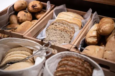 a bunch of different types of bread in boxes at Catalonia Barcelona Beach in Barcelona