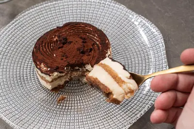 a piece of cake on a plate with a fork at Catalonia Barcelona Beach in Barcelona