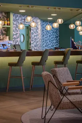 a bar in a restaurant with chairs and lights at Hesperia Barcelona Sant Just in Sant Just Desvern
