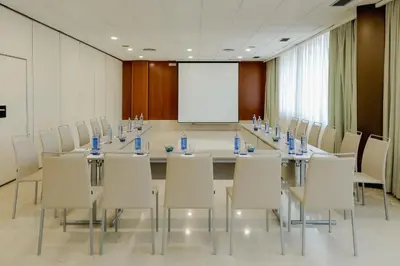 a conference room with a long table and chairs at Hesperia Barcelona Sant Just in Sant Just Desvern