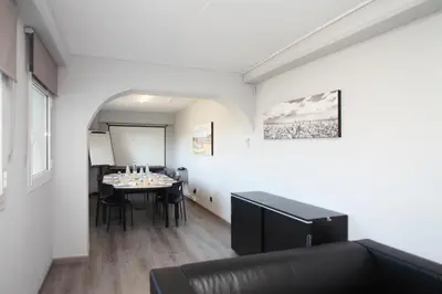 a room with a table with chairs and a couch at Travelodge Barcelona del Vallés in Barbera del Valles