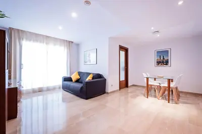 a living room with a couch and a table at Aparthotel Napols - Abapart in Barcelona
