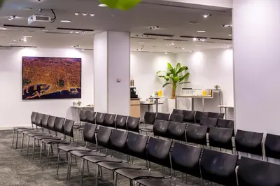 a row of chairs in a waiting room with a painting on the wall at Abba Sants in Barcelona