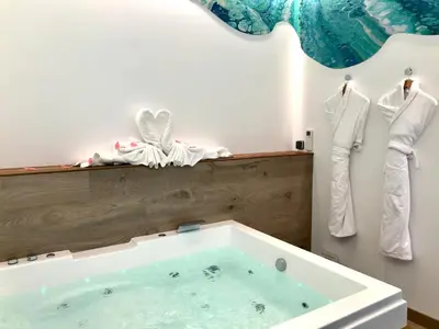 a bath tub in a bathroom with clothes hanging on a wall at Hotel Concordia Barcelona in Barcelona