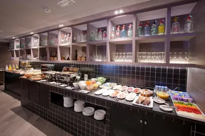 a buffet line in a restaurant with food and drinks at Hotel Concordia Barcelona in Barcelona