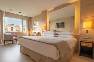 a hotel room with a large bed with a large window at Hesperia Barcelona Presidente in Barcelona