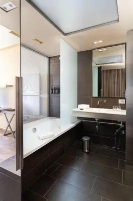 a bathroom with a tub and a sink at B Hotel in Barcelona