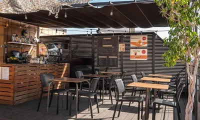 a restaurant with tables and chairs and a bar at Sunotel Aston in Barcelona