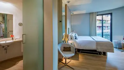 a hotel room with a bed and a bathroom at Cram Hotel in Barcelona