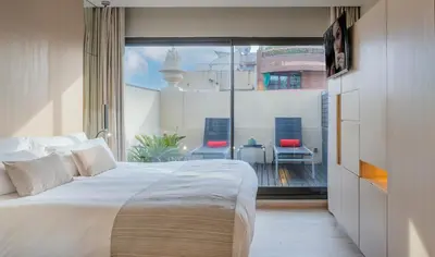 a bedroom with a white bed and a large window at Cram Hotel in Barcelona