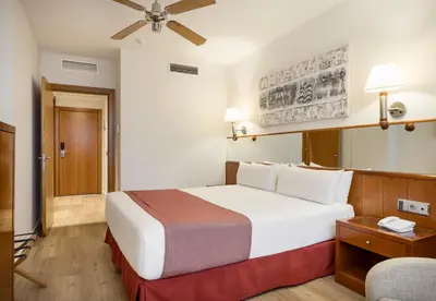 a bedroom with a large white bed in a room at Ilunion Les Corts Spa in Barcelona