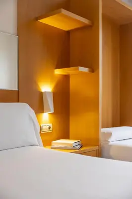 a restaurant with tables and chairs and chandeliers at Hotel SB Icaria in Barcelona