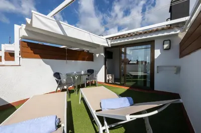 a patio with a table and chairs on the side of a house at Aparthotel Miami Park in Calella