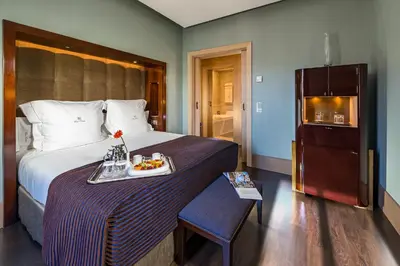 a hotel room with a bed with a tray of food on it at Hotel Casa Fuster G.L Monumento in Barcelona