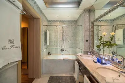 a bathroom with two sinks and a bath tub at Hotel Casa Fuster G.L Monumento in Barcelona