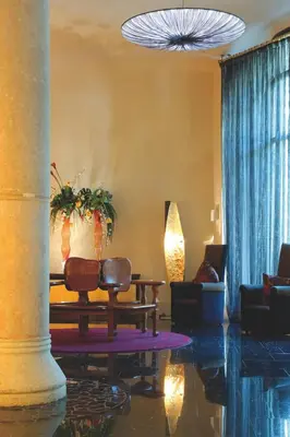 a living room with two chairs and a table at Hotel Casa Fuster G.L Monumento in Barcelona