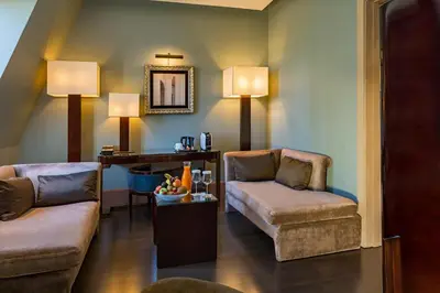 a living room with two chairs and a couch at Hotel Casa Fuster G.L Monumento in Barcelona