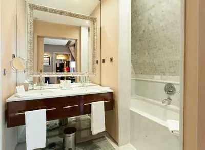 a bathroom with a sink and a tub and a mirror at Hotel Casa Fuster G.L Monumento in Barcelona
