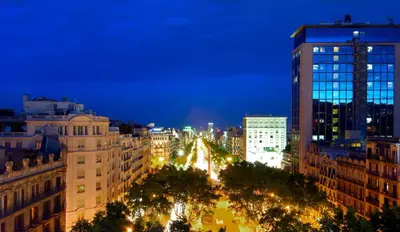 a view of a city at night at Hotel Casa Fuster G.L Monumento in Barcelona
