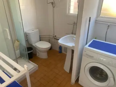 a bathroom with a washing machine and a sink at 3 BDRM APART NEAR THE SEA! GREAT FOR KIDS! in Arenys de Mar