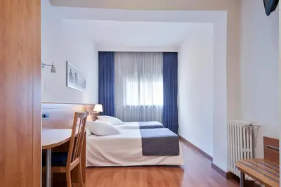 a hotel room with a bed and a table at Acta Antibes in Barcelona