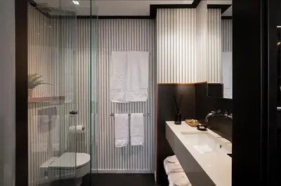 a bathroom with a shower and a sink and a toilet at Casa Elliot Hotel in Barcelona