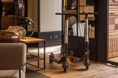 a scooter in a living room next to a table at Casa Elliot Hotel in Barcelona