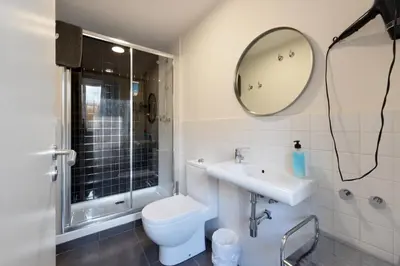 a bathroom with a toilet and a sink and a mirror at Free Hostels Barcelona in Barcelona