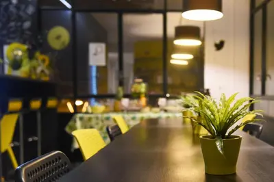 a potted plant sitting on a table in a restaurant at Free Hostels Barcelona in Barcelona