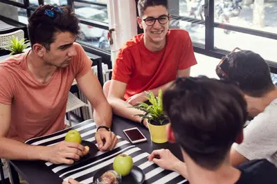 a group of people sitting around a table with apples on it at Free Hostels Barcelona in Barcelona