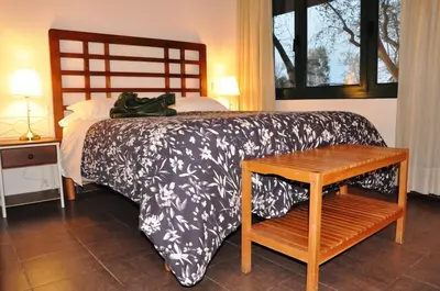 a bed with a black and white blanket and a table at La Ciudadela in Barcelona