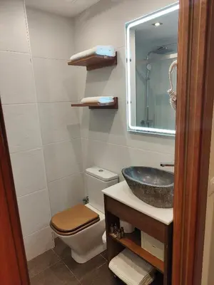 a bathroom with a sink and a toilet and a mirror at La Ciudadela in Barcelona