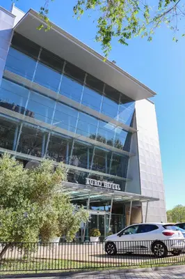 a white car parked in front of a building at Eurohotel Barcelona Granvia Fira in Hospitalet de Llobregat