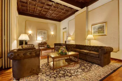 a hotel room with two beds and a table and chairs at Hotel Roger de Llúria in Barcelona