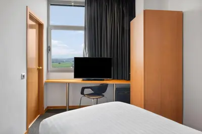 a bedroom with a desk with a computer and a bed at B&B HOTEL Barcelona Mollet Porta de Gallecs in Mollet del Vallès