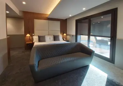 a bedroom with a bed and a couch in it at Best Western Premier Hotel Dante in Barcelona