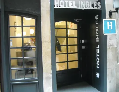 an entrance to a hotel with two glass doors at Hotel Inglés in Barcelona