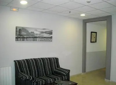 a couch in a room with a picture on the wall at Hotel Inglés in Barcelona