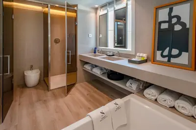 a bathroom with a tub and a toilet and a sink at Bel Air in Castelldefels