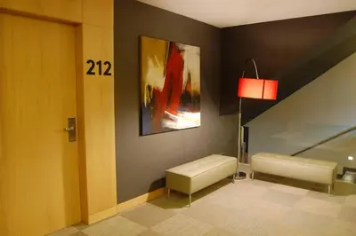 a room with a couch and a painting on the wall at Hotel Urpí in Sabadell