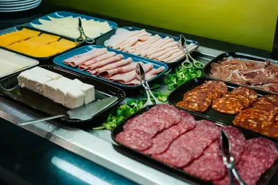 a buffet with different types of meats and cheese at Abba Rambla Hotel in Barcelona