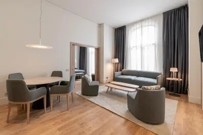 a bedroom with a bed and a desk and a mirror at Gran Hotel Havana 4Sup by Escampa Hotels in Barcelona