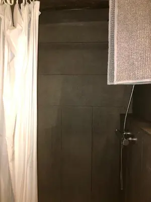 a bathroom with a shower with a white curtain at Charming house next to the sea and Barcelona for 6 in Badalona