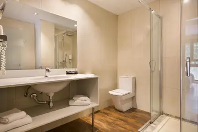 a bathroom with a sink and a toilet and a shower at Hotel Acta Azul Barcelona in Barcelona