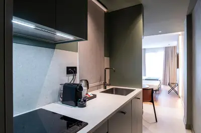 a kitchen with a sink and a counter top at Aparthotel Atenea Calabria in Barcelona