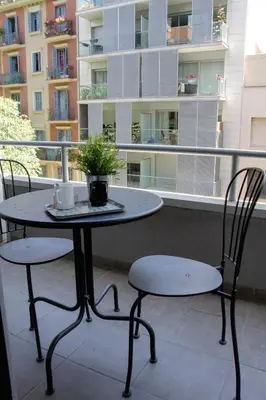 a table and two chairs on a balcony at Aparthotel Atenea Calabria in Barcelona