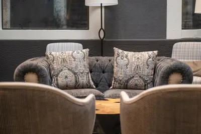 a table and chairs in a room with a lamp on it at Hesperia Barcelona Barri Gòtic in Barcelona
