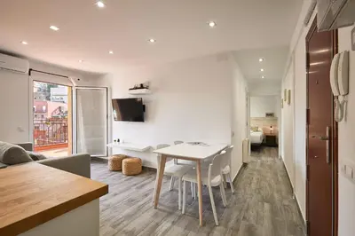a kitchen and living room with a table and chairs at BBarcelona El Carmel Apartment with terrace in Barcelona